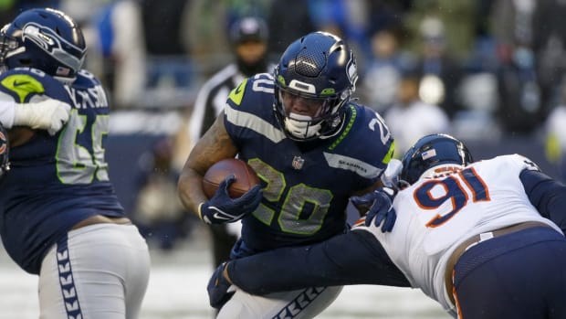Dec 26, 2021; Seattle, Washington, USA; Seattle Seahawks running back Rashaad Penny (20) rushes against the Chicago Bears during the fourth quarter at Lumen Field. Mandatory Credit: Joe Nicholson-USA TODAY Sports